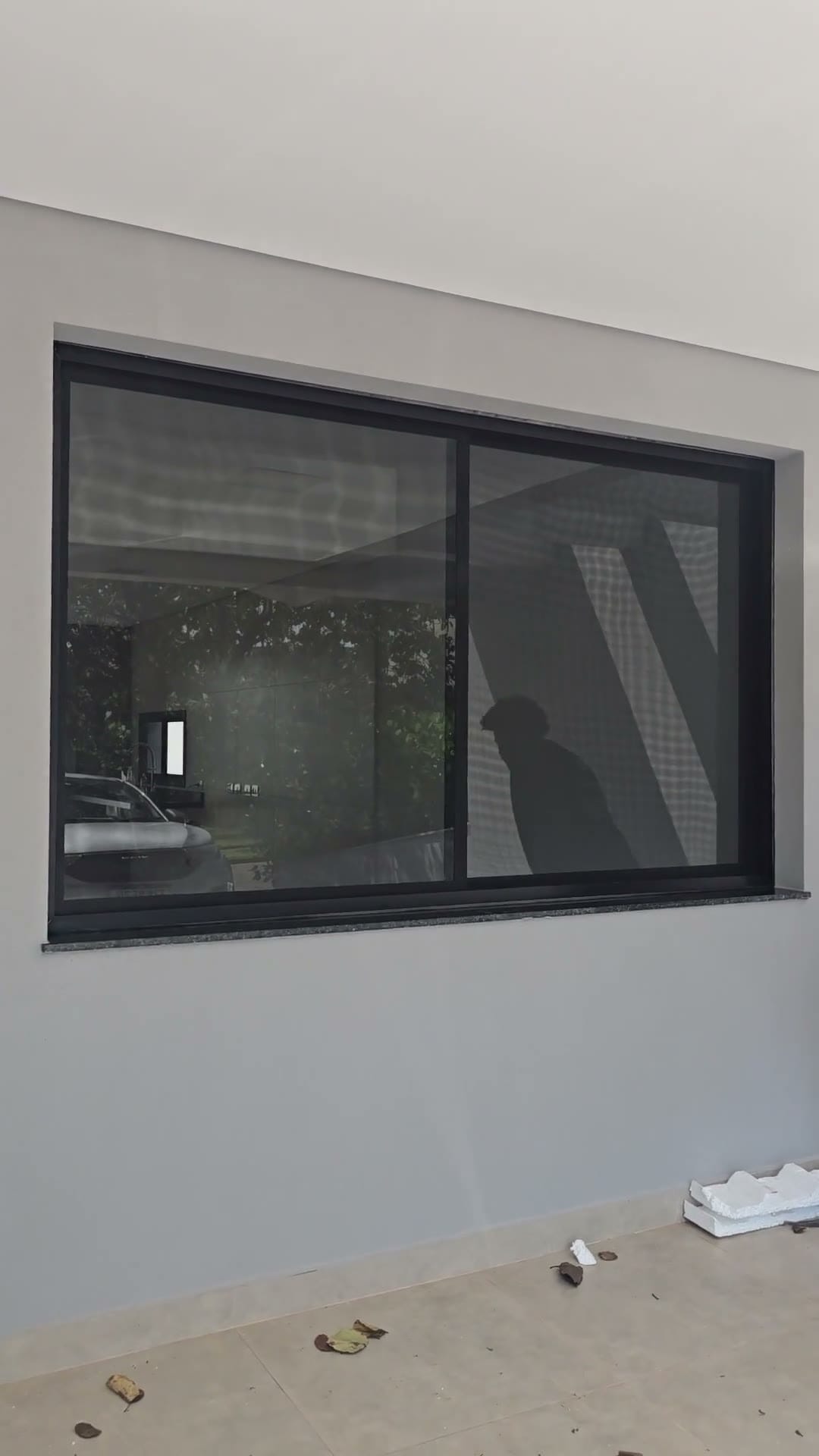 Janela grande de perfil preto com quadro de tela mosquiteira feito sob medida e já instalado, em Piracicaba